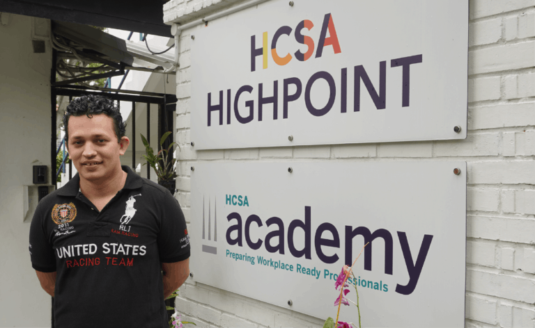 Christoper standing in front of HCSA Highpoint sign