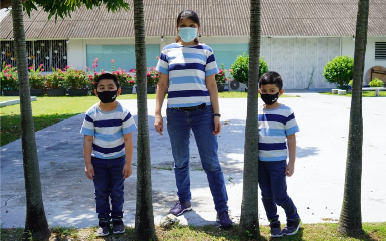 Suhaini and her two boys on HCSA's compound